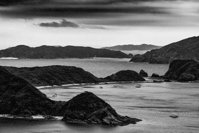 Scenic view of sea and mountains against sky