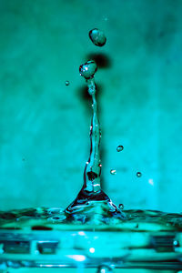 Close-up of water drop against blue background