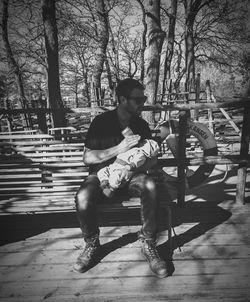 Full length of woman standing on tree trunk