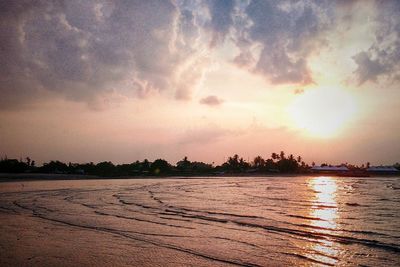 Scenic view of lake against sky at sunset