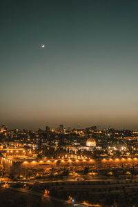 High angle view of illuminated buildings against sky at night