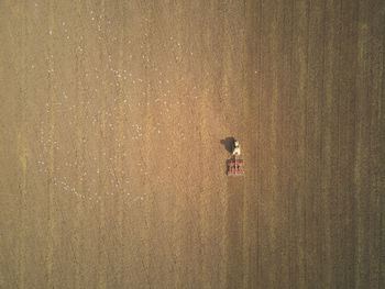 Drone aerial shots of a tractor ploughing a field at stone creek, sunk island, east yorkshire, uk.