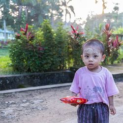 Portrait of boy standing outdoors