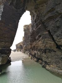 Scenic view of sea seen through cave