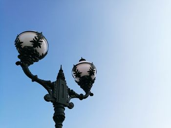 Low angle view of street light against clear blue sky