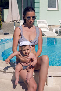 Mother and son sitting near the pool at the resort