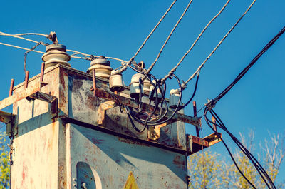 Transformer booth with high voltage power lines. blue sky background