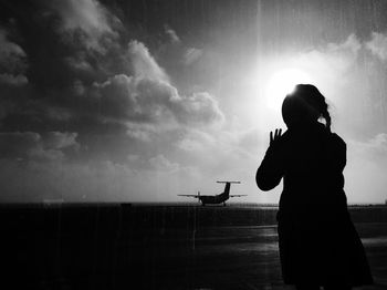 Silhouette girl looking at airplane