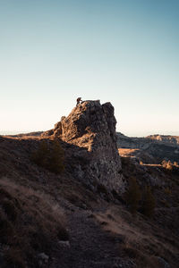 Rock formations on landscape against clear sky