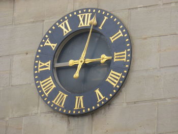 Low angle view of clock on wall