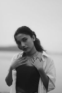 Young woman standing against white background