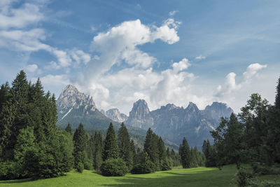 Scenic view of green landscape and mountains against sky