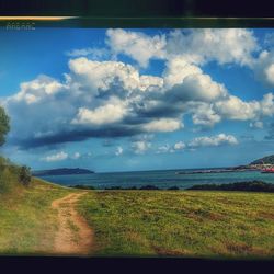 Scenic view of landscape against cloudy sky