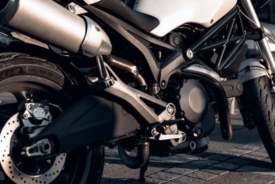 Close-up photo of dark grey road motorbike parked in city