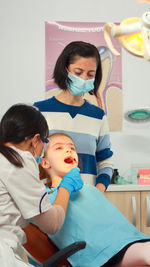 Female doctor examining patient at clinic