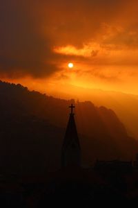 Silhouette of church against sky during sunset