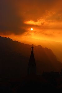 Silhouette temple against sky during sunset