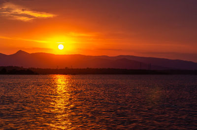 Scenic view of sea against orange sky