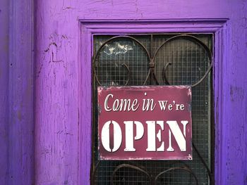 Wooden door with come in we are open sign