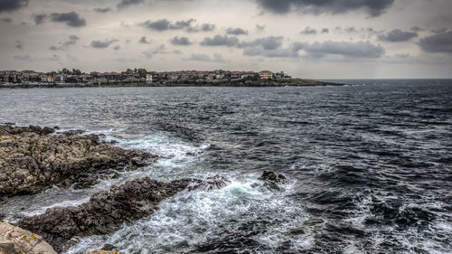 Scenic view of sea against cloudy sky