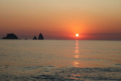 Scenic view of sea against orange sky