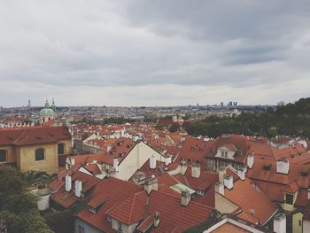 High angle view of houses in town against sky