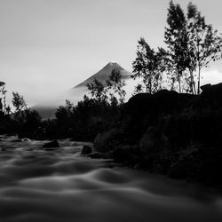 Scenic view of waterfall against sky