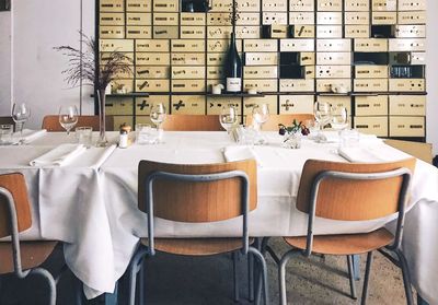 Empty chairs and tables in restaurant