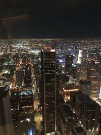 High angle view of illuminated buildings in city at night