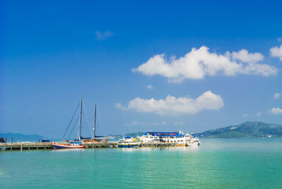 Sailboats in sea against sky