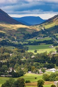 Scenic view of field and mountains against sky