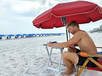Young man millennial in his office as beach chairman.