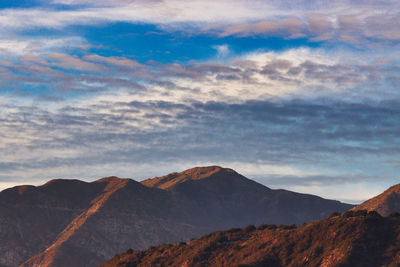 View of mountain range against cloudy sky