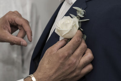 Close-up of man holding roses