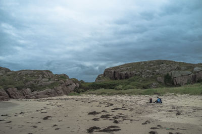 Scenic view of mountains against cloudy sky