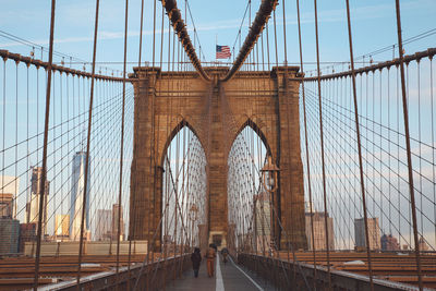 Low angle view of brooklyn bridge in city against sky