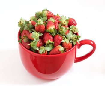 Close-up of strawberries over white background