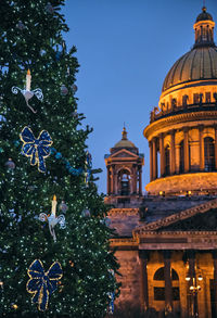 Low angle view of christmas tree against building