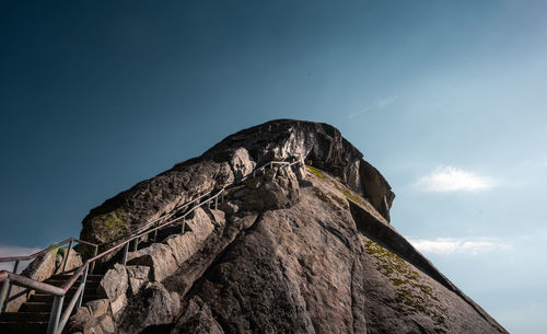 Low angle view of rock formation against sky