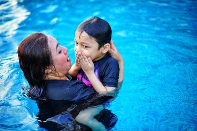 Mother and son in swimming pool