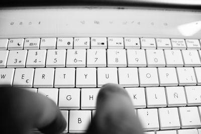 Close-up of hand using laptop