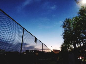 Low angle view of building seen through chainlink fence