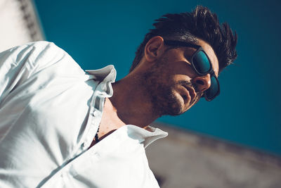 Close-up portrait of young man wearing sunglasses