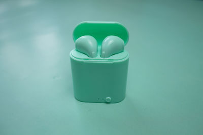High angle view of green tea light against blue background