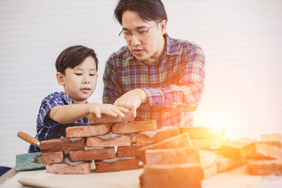 Father and son on table