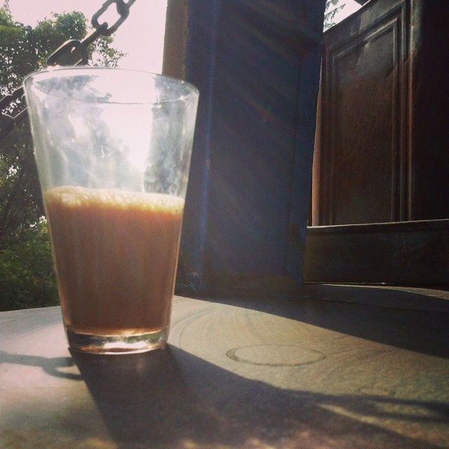 drink, food and drink, refreshment, drinking glass, table, glass - material, freshness, indoors, transparent, glass, close-up, still life, window, sunlight, drinking straw, alcohol, no people, focus on foreground, day, shadow