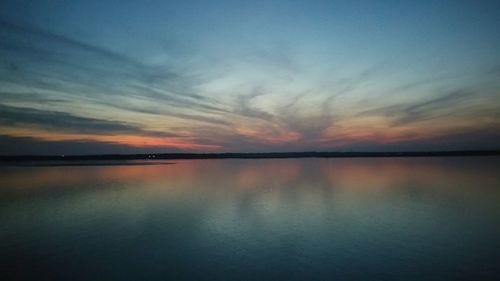 Reflection of clouds in water at sunset