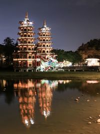 Reflection of building in lake at night