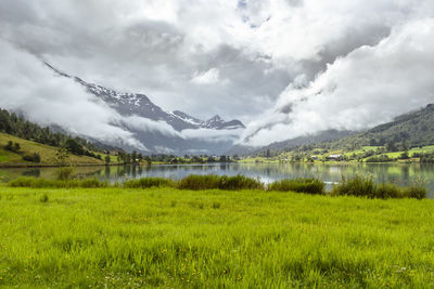 Scenic view of lake and mountains against sky