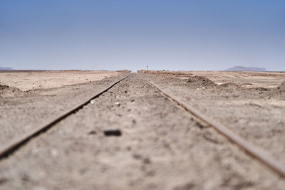 Railway tracks to nowhere leading straight to the horizon in the atacama desert of chile. 